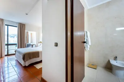 a hotel room with two beds and a window at Salema Beach Hotel in Salema