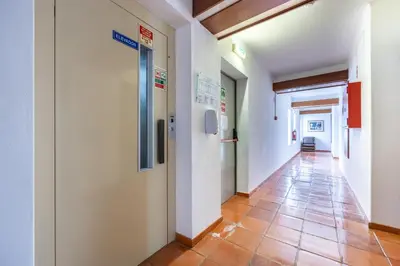a hallway in a hospital with a tile floor at Salema Beach Hotel in Salema