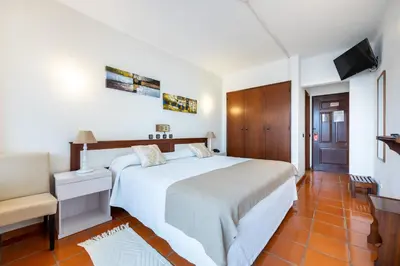 a hotel room with a bed and a sink at Salema Beach Hotel in Salema
