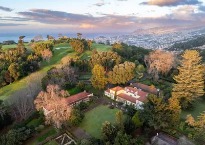 an aerial view of a house with trees at Casa Velha do Palheiro Relais & Chateaux in Funchal