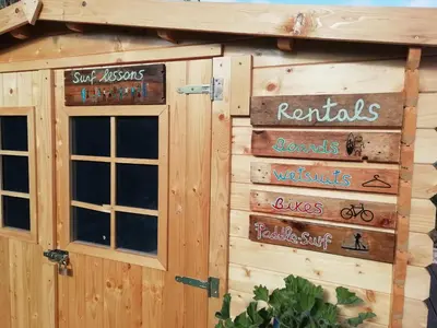 a building with signs on the side of it at Blacksheep Sagres Guesthouse & Surf in Sagres