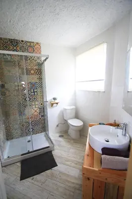 a bathroom with a shower and a sink and a toilet at Blacksheep Sagres Guesthouse & Surf in Sagres