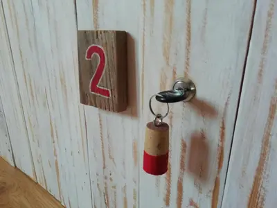 a lock on a wooden door with a key at Blacksheep Sagres Guesthouse & Surf in Sagres