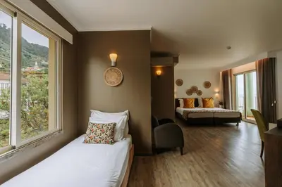 a hotel room with a bed and a window at Hotel Euro Moniz in Porto Moniz