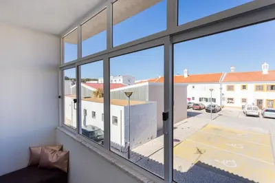 a room with windows looking out at a parking lot at Casa da Vila in Vila do Bispo