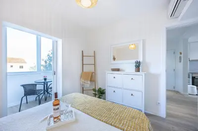 a bedroom with a bed and a dresser and a window at Casa da Vila in Vila do Bispo