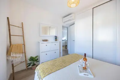 a bedroom with a bed and a table with wine glasses at Casa da Vila in Vila do Bispo