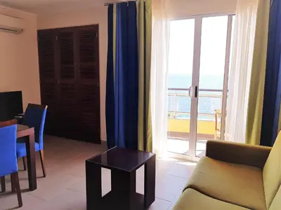 a living room with a view of the ocean at Hotel Cais da Oliveira in Caniço