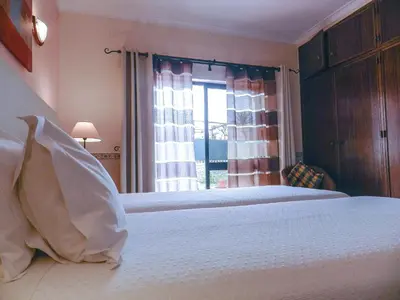 a bedroom with a white bed and a window at Residencia Julio in Sagres