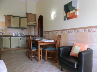 a kitchen with a table and a chair and a table at Residencia Julio in Sagres