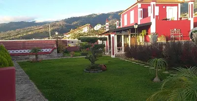 a house with a yard with green grass at the old school in Calheta