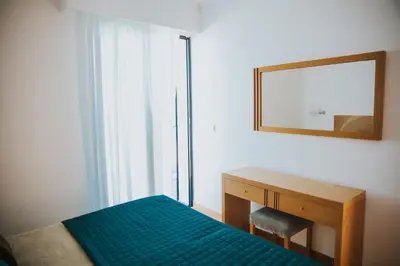 a bedroom with a bed and a mirror and a desk at Casa da Capelinha in Ponta Delgada