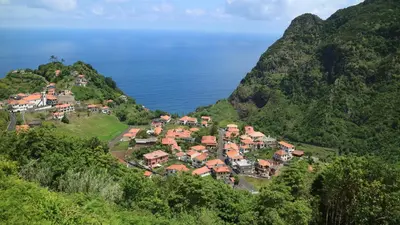an aerial view of a village on a hill next to the ocean at Casa da Capelinha in Ponta Delgada