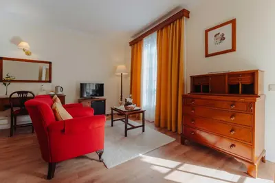 a living room with a red chair and a dresser at Quinta da Bela Vista in Funchal