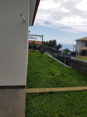 a view of a field of grass with a fence at migs'place in Arco da Calheta