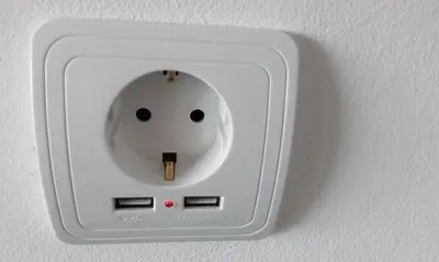 a lightswitch on a wall with a face on it at migs'place in Arco da Calheta