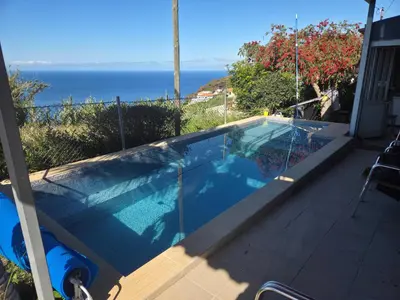a swimming pool with a view of the ocean at Canto da Manu Panoramic in Calheta