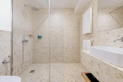 a white bathroom with a sink and a tub at Hotel Orquidea in Funchal