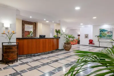 a lobby with a waiting area with chairs and a couch at Hotel Orquidea in Funchal