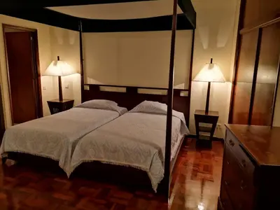 a bedroom with a large bed with two lamps at Residencial Colombo in Funchal