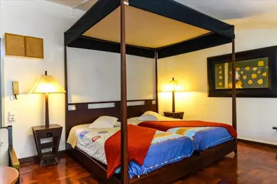 a bedroom with a bed with a canopy at Residencial Colombo in Funchal