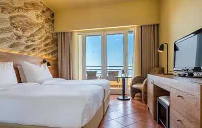 a hotel room with a bed and a television at Calheta Beach - All-inclusive - Savoy Signature in Calheta