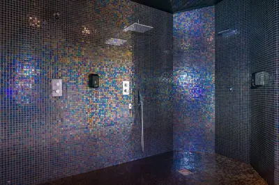 a blue tiled bathroom with a shower with blue lights at Calheta Beach - All-inclusive - Savoy Signature in Calheta