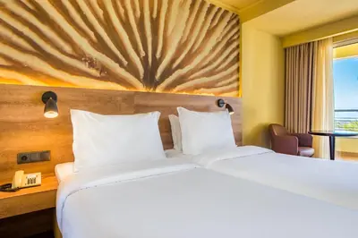 a hotel room with a large bed and a window at Calheta Beach - All-inclusive - Savoy Signature in Calheta