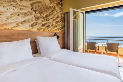 a bedroom with a bed with a view of the ocean at Calheta Beach - All-inclusive - Savoy Signature in Calheta