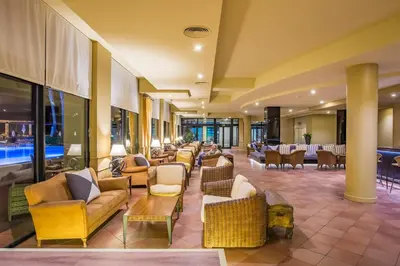 a lobby with couches and chairs and tables at Calheta Beach - All-inclusive - Savoy Signature in Calheta