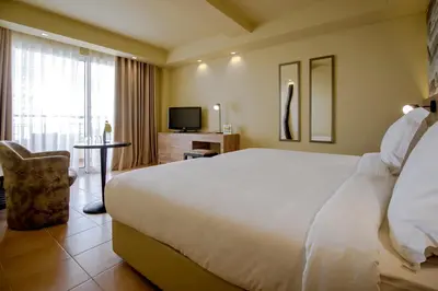 a hotel room with a large bed and a television at Calheta Beach - All-inclusive - Savoy Signature in Calheta