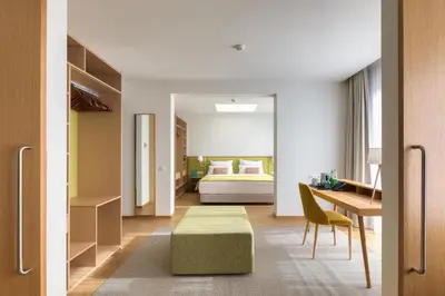 a bedroom with a bed and a desk and a table at Sentido Galomar - Adults Only in Caniço