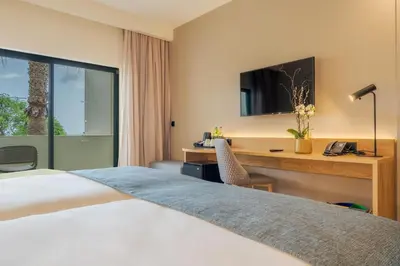 a hotel room with a bed and a desk at Sentido Galosol in Caniço