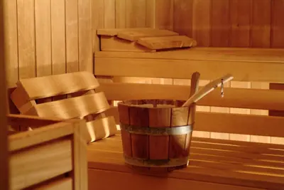 a tub in a sauna with a bucket at Suite Hotel Eden Mar - PortoBay in Funchal