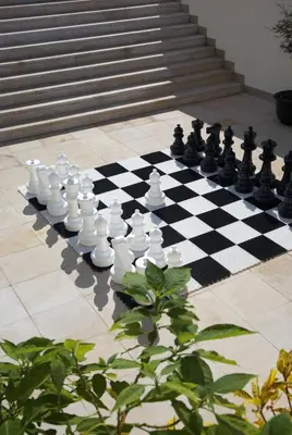 a chess board with chess pieces on a checkerboard at Suite Hotel Eden Mar - PortoBay in Funchal