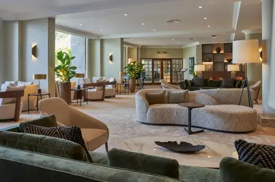 a hotel lobby with couches and chairs and tables at The Cliff Bay - PortoBay in Funchal