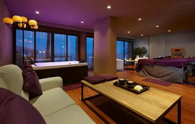 a living room with a bath tub and a bedroom at The Cliff Bay - PortoBay in Funchal