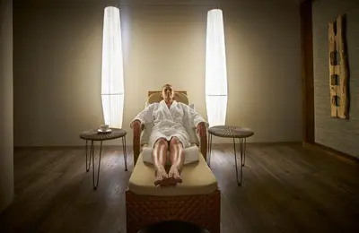 a room with two beds with lights on the wall at Hotel Porto Mare - PortoBay in Funchal