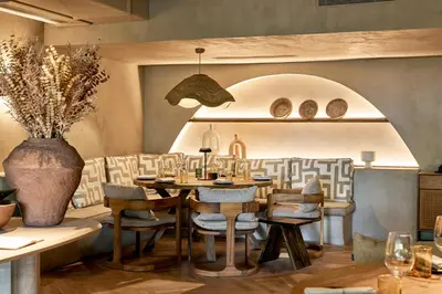 a bar in a restaurant with people in the background at Hotel Porto Mare - PortoBay in Funchal