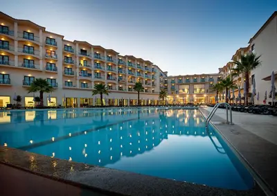 a hotel with a swimming pool in front of a building at Vila Gale Santa Cruz in Santa Cruz