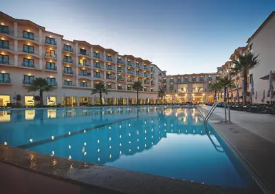 a hotel with a swimming pool in front of a building at Vila Gale Santa Cruz in Santa Cruz
