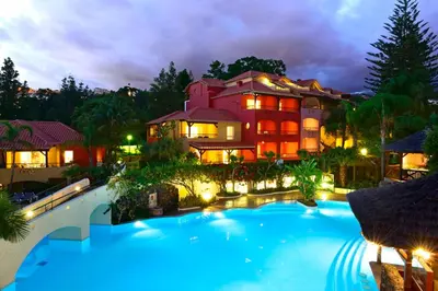 a large house with a swimming pool in front of it at Pestana Village Garden Hotel in Funchal