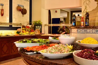 a buffet with bowls of vegetables on a table at Pestana Village Garden Hotel in Funchal