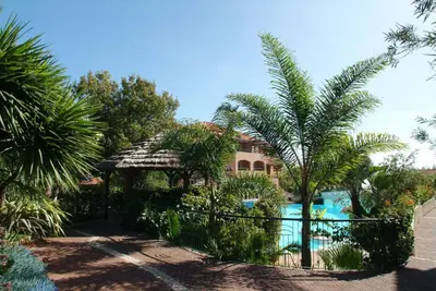 a resort with a swimming pool and palm trees at Pestana Village Garden Hotel in Funchal