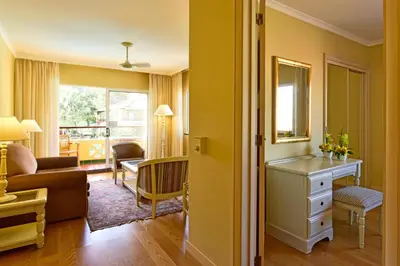 a living room with a couch and a table at Pestana Village Garden Hotel in Funchal
