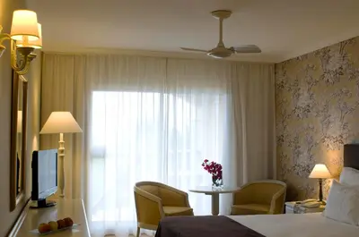 a hotel room with a bed and a window at Pestana Village Garden Hotel in Funchal
