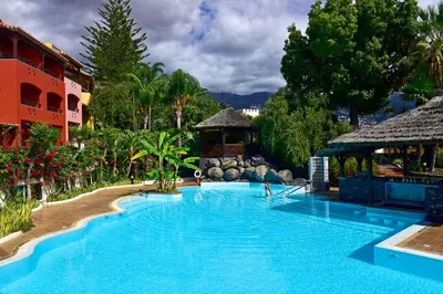 a large pool at a resort with people in it at Pestana Village Garden Hotel in Funchal