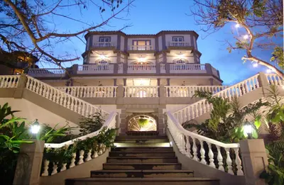 a large building with stairs leading up to it at Pestana Miramar Garden & Ocean Hotel in Funchal