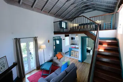 a living room with a staircase and a living room at Quinta das Vinhas in Calheta