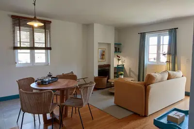 a living room with a couch and a table at Quinta das Vinhas in Calheta